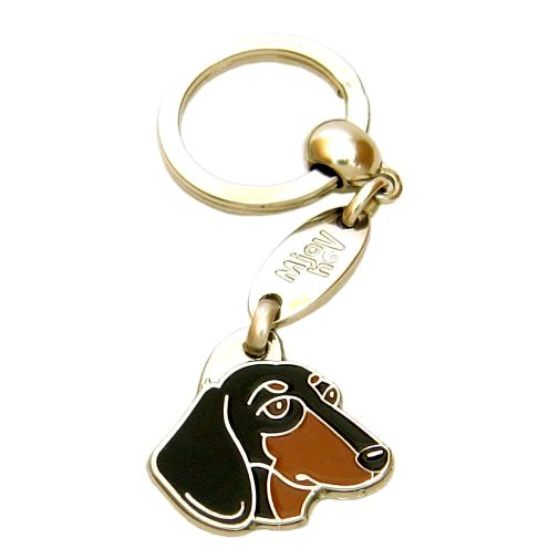 <h3>Custom personalized dog name tag Dachshund black and tan</h3>
This unique, cute and quality dog id tag is offered with laser-engraved name and phone number or your custom text. It comes with a stainless steel split ring for easy attachment to your pet’s collar. All items are also available as keychains.
A perfect gift for dogs and dog lovers.

<strong>Color:</strong> colored/silver
<strong>Size:</strong> 29 x 28 mm (1.14 x 1.10 inch)
<strong>Engraving area:</strong> 17 x 12 mm (0.67 x 0.47 inch); recommended layout up to 4 lines, 15 characters per line.

Laser engraving on the back side is included in the price. Please enter the text you would like engraved (recommended: dog’s name and phone number). The engraving will be centered and easy to read. 
<strong>Important:</strong> If you exceed the recommended text length, the engraving will be significantly smaller and may become difficult to read. For best readability, we strongly recommend keeping the text short and clear.

Metal, chrome plated dog tag or key ring. 
Hand made, hand colored, made in Slovenia. 

In stock.

<h3>About the breed – Dachshund black and tan</h3>
The Dachshund (Dackel, Wiener Dog) is a brave, lively, and loyal dog breed originating from Germany. It belongs to <strong>FCI Group 4 (Dachshunds)</strong>. Recognized for its long body and short legs, this unique breed was originally developed for hunting badgers and other burrowing animals. Dachshunds are affectionate family dogs, good with children, and surprisingly alert, making them excellent watchdogs despite their small size. They are active, persistent, and full of character, often showing a strong independent streak. Their distinctive appearance and bold personality make them truly unforgettable companions. A personalized engraved dog tag is a stylish and practical accessory that enhances their charm while ensuring safety.
